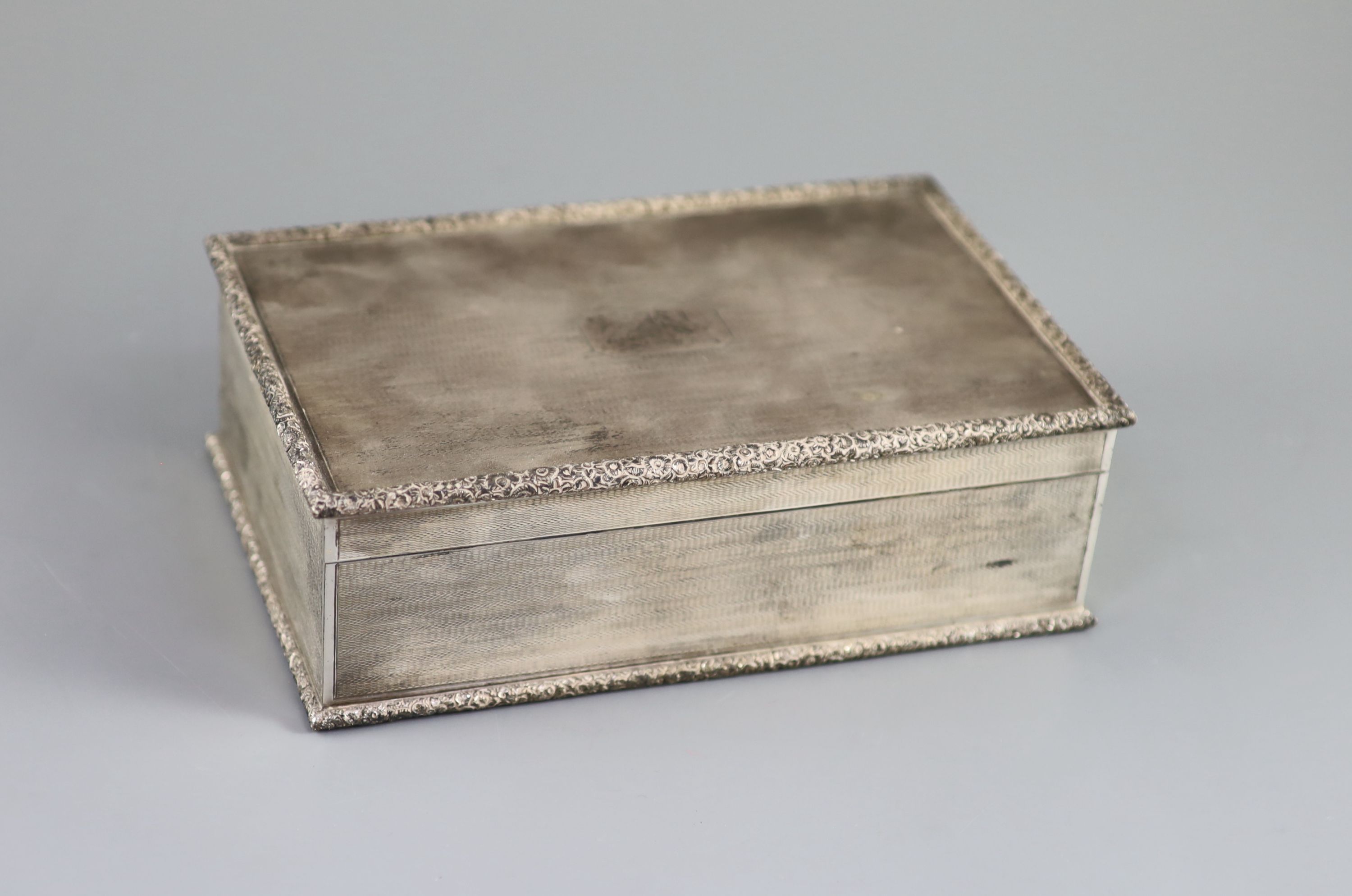 A 1950's engine turned silver rectangular cigarette box, by Mappin & Webb, 21.1cm, gross 35oz.